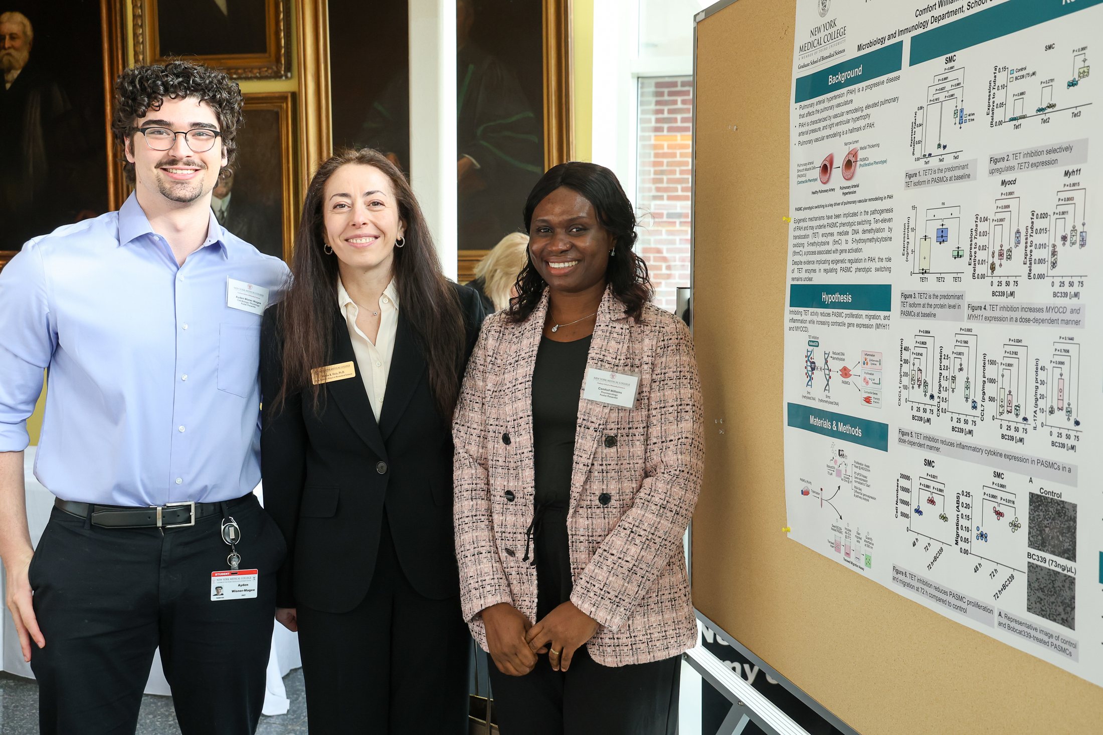 Ayden with faculty beside a scientific poster